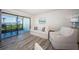 Bright living room with sliding glass doors to outdoor patio and white comfortable furniture at 6265 Sun Blvd # 115, St Petersburg, FL 33715