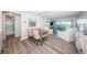 Bright open floorplan with dining area and beachfront views through sliding doors at 6265 Sun Blvd # 115, St Petersburg, FL 33715