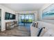 Beachfront views from the living room, comfortable seating, and a flat screen TV at 6265 Sun Blvd # 115, St Petersburg, FL 33715
