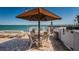Community outdoor lounge area with a covered table and chairs overlooking the beach at 6265 Sun Blvd # 115, St Petersburg, FL 33715