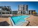 Community pool with resort-style deck and spa with nearby building at 6265 Sun Blvd # 115, St Petersburg, FL 33715