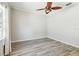 Bright bedroom features light gray walls, gray wood-look flooring, and ceiling fan at 6939 3Rd N St, St Petersburg, FL 33702