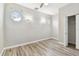 An empty bedroom with unique windows, neutral walls, and wood-look flooring at 6939 3Rd N St, St Petersburg, FL 33702