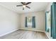 Bedroom view features large window, gray wood-look floors, ceiling fan and light gray walls at 6939 3Rd N St, St Petersburg, FL 33702