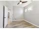 Neutral bedroom featuring modern lighting, ceiling fan and wood-look laminate flooring at 6939 3Rd N St, St Petersburg, FL 33702