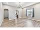 Bright dining room features hardwood floors, modern lighting, and an arched doorway at 6939 3Rd N St, St Petersburg, FL 33702