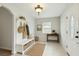 A cozy foyer featuring a coat rack with bench and a small side table at 6939 3Rd N St, St Petersburg, FL 33702