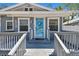 Close-up of the inviting front porch with a light blue door and decorative wreath at 6939 3Rd N St, St Petersburg, FL 33702