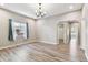 Open-concept living room featuring wood-look floors and a large window at 6939 3Rd N St, St Petersburg, FL 33702