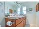 Bathroom vanity with double sinks, a large mirror, and stylish lighting at 775 S Bayshore Blvd, Safety Harbor, FL 34695