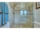 Bathroom shower with stone tile and glass doors, offering a luxurious bathing experience at 775 S Bayshore Blvd, Safety Harbor, FL 34695