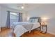 Bright bedroom featuring hardwood floors, a ceiling fan, and a comfortable bed with stylish bedding at 775 S Bayshore Blvd, Safety Harbor, FL 34695