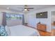 Bedroom with a ceiling fan, closet, and a window view of the lake at 775 S Bayshore Blvd, Safety Harbor, FL 34695