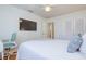 Well-lit bedroom with a ceiling fan, and a wall-mounted TV and closet at 775 S Bayshore Blvd, Safety Harbor, FL 34695
