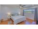 Bedroom featuring hardwood floors, a ceiling fan, and a comfortable bed with stylish bedding at 775 S Bayshore Blvd, Safety Harbor, FL 34695
