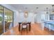 Bright dining room featuring hardwood floors, white paneled walls, and sliding glass doors leading to the porch at 775 S Bayshore Blvd, Safety Harbor, FL 34695