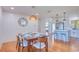 Open dining room features wood floors, table with six chairs, and stylish wicker pendant lighting at 775 S Bayshore Blvd, Safety Harbor, FL 34695