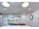 Dining area with view to screened lanai; features seating for six, modern lighting, and white paneling at 775 S Bayshore Blvd, Safety Harbor, FL 34695