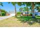 Beautiful single-story house featuring an attached garage and a lush green lawn at 775 S Bayshore Blvd, Safety Harbor, FL 34695