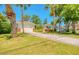 Charming single-story home with a well-manicured lawn and mature palm trees at 775 S Bayshore Blvd, Safety Harbor, FL 34695