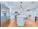 Modern kitchen with stainless steel refrigerator, white cabinets, and center island with pendant lighting at 775 S Bayshore Blvd, Safety Harbor, FL 34695