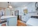 Modern kitchen with stainless steel appliances, white cabinets, and center island with pendant lights at 775 S Bayshore Blvd, Safety Harbor, FL 34695