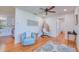 Cozy living room with hardwood floors, a hanging chair, and an adjacent kitchen area at 775 S Bayshore Blvd, Safety Harbor, FL 34695