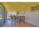 Relaxing screened patio with tile flooring, a bar, and comfortable seating for outdoor entertaining at 775 S Bayshore Blvd, Safety Harbor, FL 34695