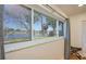 Bedroom window featuring a water view, trees, and a glimpse of neighboring homes at 775 S Bayshore Blvd, Safety Harbor, FL 34695