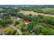 An aerial view shows a single-story home surrounded by trees, with a nearby field and other houses at 117 Myrtle Ln, Plant City, FL 33565
