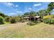 Expansive backyard with a metal pergola, beautiful landscaping, and ample space at 117 Myrtle Ln, Plant City, FL 33565