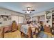 Well-lit bedroom with a ceiling fan, multiple windows, and framed photos and collectables at 117 Myrtle Ln, Plant City, FL 33565