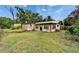 Exterior view of a single-Gathering home with a metal roof surrounded by a lush green lawn at 117 Myrtle Ln, Plant City, FL 33565