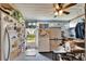 Practical kitchen featuring a refrigerator, white cabinets, and a dining area with lots of natural light at 117 Myrtle Ln, Plant City, FL 33565
