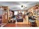 Comfortable living room with wood-paneled walls, a cozy fireplace, and comfortable seating at 117 Myrtle Ln, Plant City, FL 33565