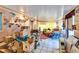 Bright living room filled with furnishings, boxes, and collectibles, and ample lighting from the windows at 117 Myrtle Ln, Plant City, FL 33565