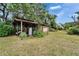Storage area with a metal roof and greenery offering ample storage space and functionality at 117 Myrtle Ln, Plant City, FL 33565