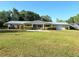 Charming single-story home with a well-manicured lawn and beautiful landscaping at 1203 Durant Rd, Brandon, FL 33511