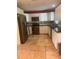 Well-lit kitchen with stainless steel appliances, granite countertops, and white cabinets at 1203 Durant Rd, Brandon, FL 33511