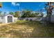 View of backyard with shed, fencing and a mix of wild and cultivated greenery, promising a serene outdoor space at 122 10Th Ave, Indian Rocks Beach, FL 33785