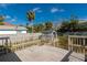 Backyard showing deck, storage shed, trees and fence for enjoying serene outdoor living at 122 10Th Ave, Indian Rocks Beach, FL 33785
