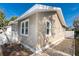 Charming exterior view of home featuring neutral siding, white trim, and manicured gravel landscaping against a bright blue sky at 122 10Th Ave, Indian Rocks Beach, FL 33785