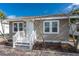 Inviting home exterior with a small porch and tidy landscaping at 122 10Th Ave, Indian Rocks Beach, FL 33785