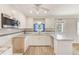Well-lit kitchen with stainless steel appliances and beachy decor at 122 10Th Ave, Indian Rocks Beach, FL 33785