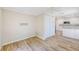 Living room opens up to kitchen with wood floors and closet for storage at 122 10Th Ave, Indian Rocks Beach, FL 33785