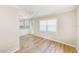 Living room adjacent to kitchen with door to exterior and large window at 122 10Th Ave, Indian Rocks Beach, FL 33785