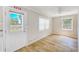 Living room features wood floors, windows and glass paneled door to exterior at 122 10Th Ave, Indian Rocks Beach, FL 33785