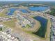 Aerial view showcasing the community's layout, featuring scenic ponds and homes, complete with neighborhood streets at 12795 Fisherville Way, Riverview, FL 33579