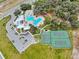 A sprawling community layout showcasing a pool, tennis courts, parking, and lush landscaping at 12795 Fisherville Way, Riverview, FL 33579