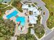 A top-down view of the community center featuring a pool, splash pad, and manicured green spaces at 12795 Fisherville Way, Riverview, FL 33579